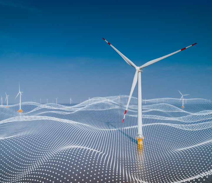 Wind turbines in the ocean with a blue sky.