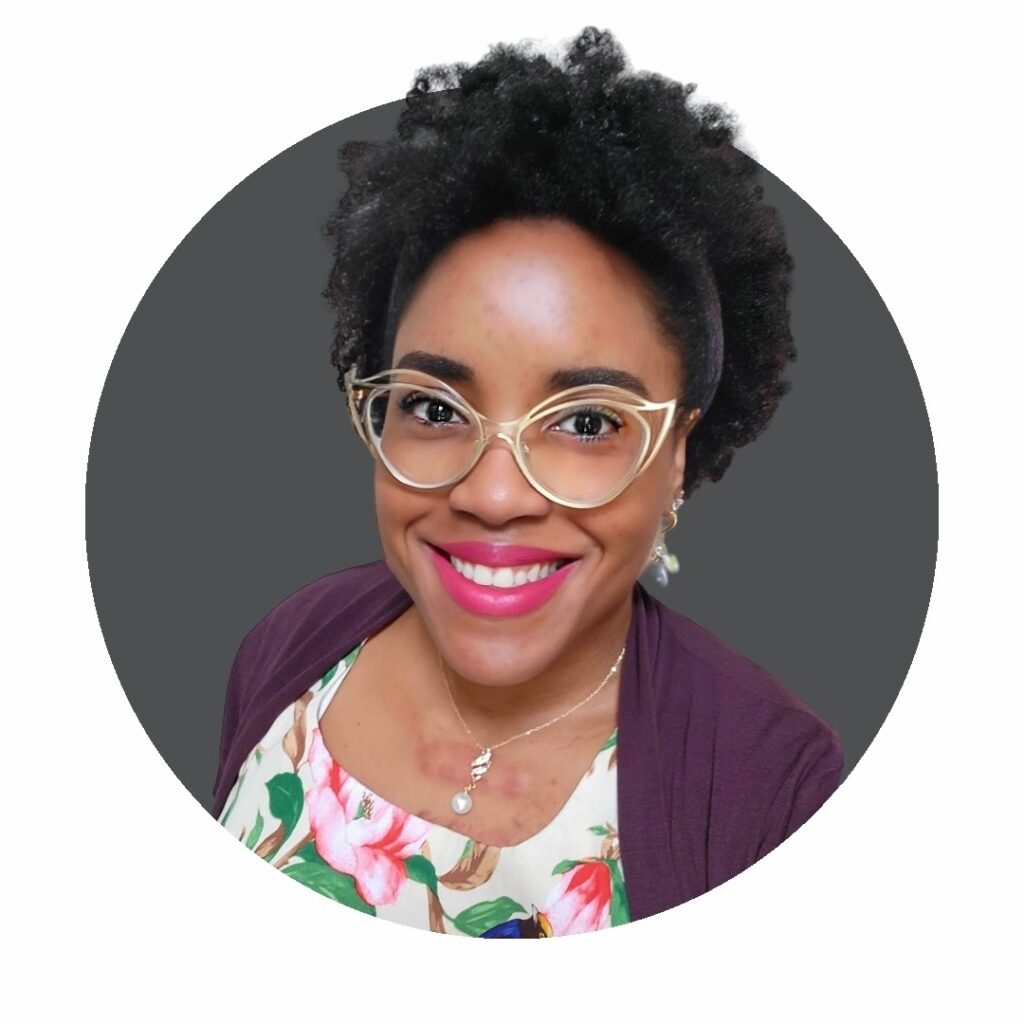 A black woman wearing glasses and a floral top.