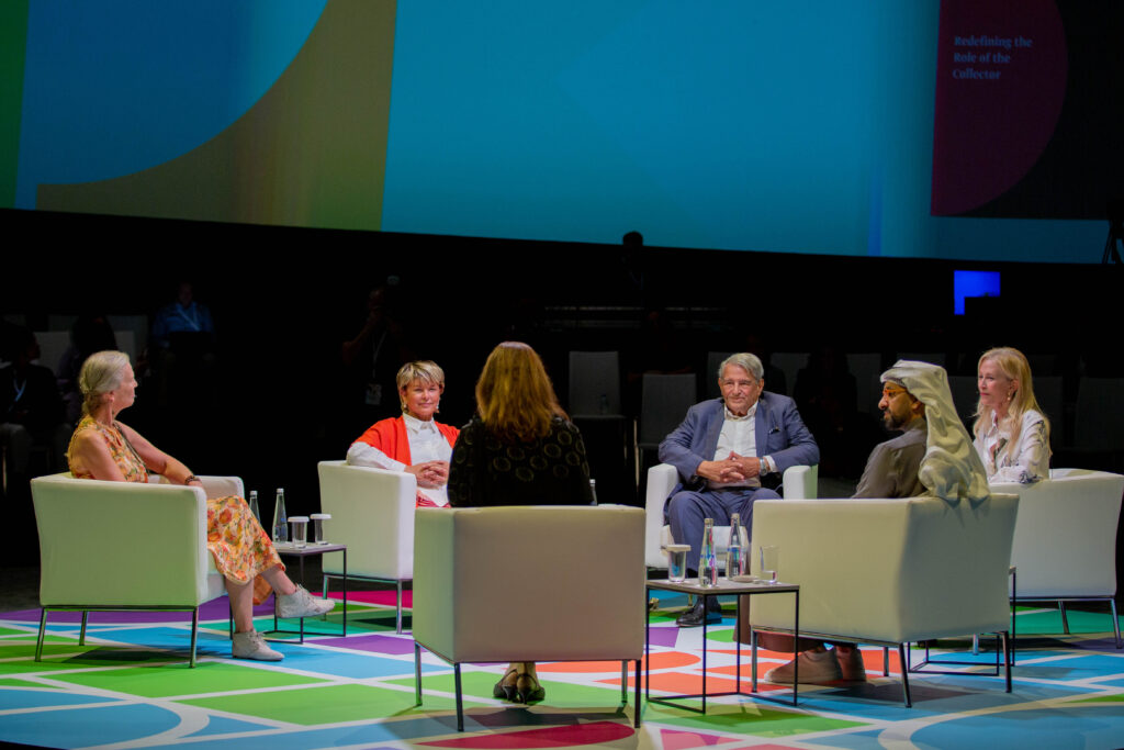 A group of people sitting in chairs on a stage.