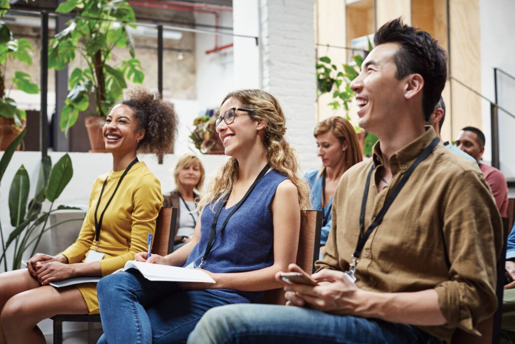 A group of people sitting in a meeting room.
